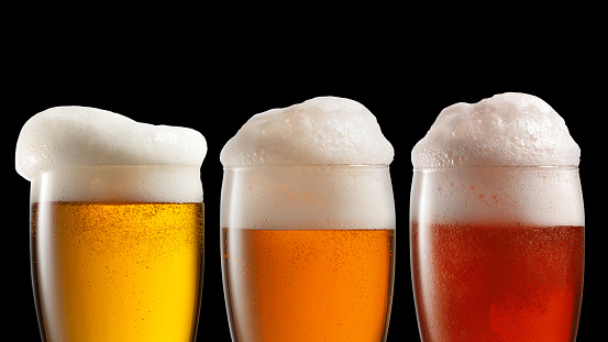 Different beer in glasses isolated on black background. Header for website