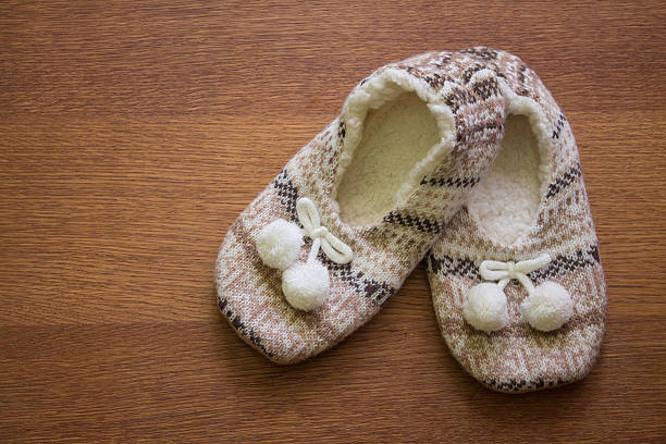 istock Knitted slippers with pompoms 506814898