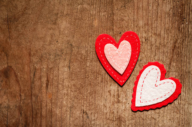 istock Red and pink hearts on a rustic wood background 506815162