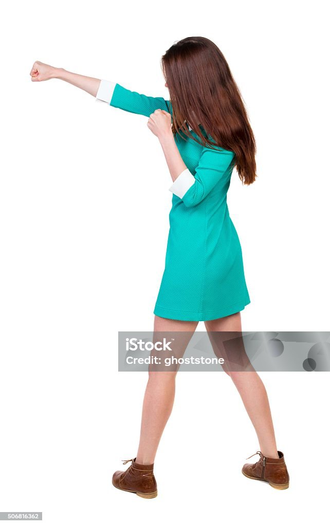 skinny woman funny fights waving his arms and legs. skinny woman funny fights waving his arms and legs. Rear view people collection.  backside view of person.  Isolated over white background. Girl in aqua dress beats hand. Adult Stock Photo