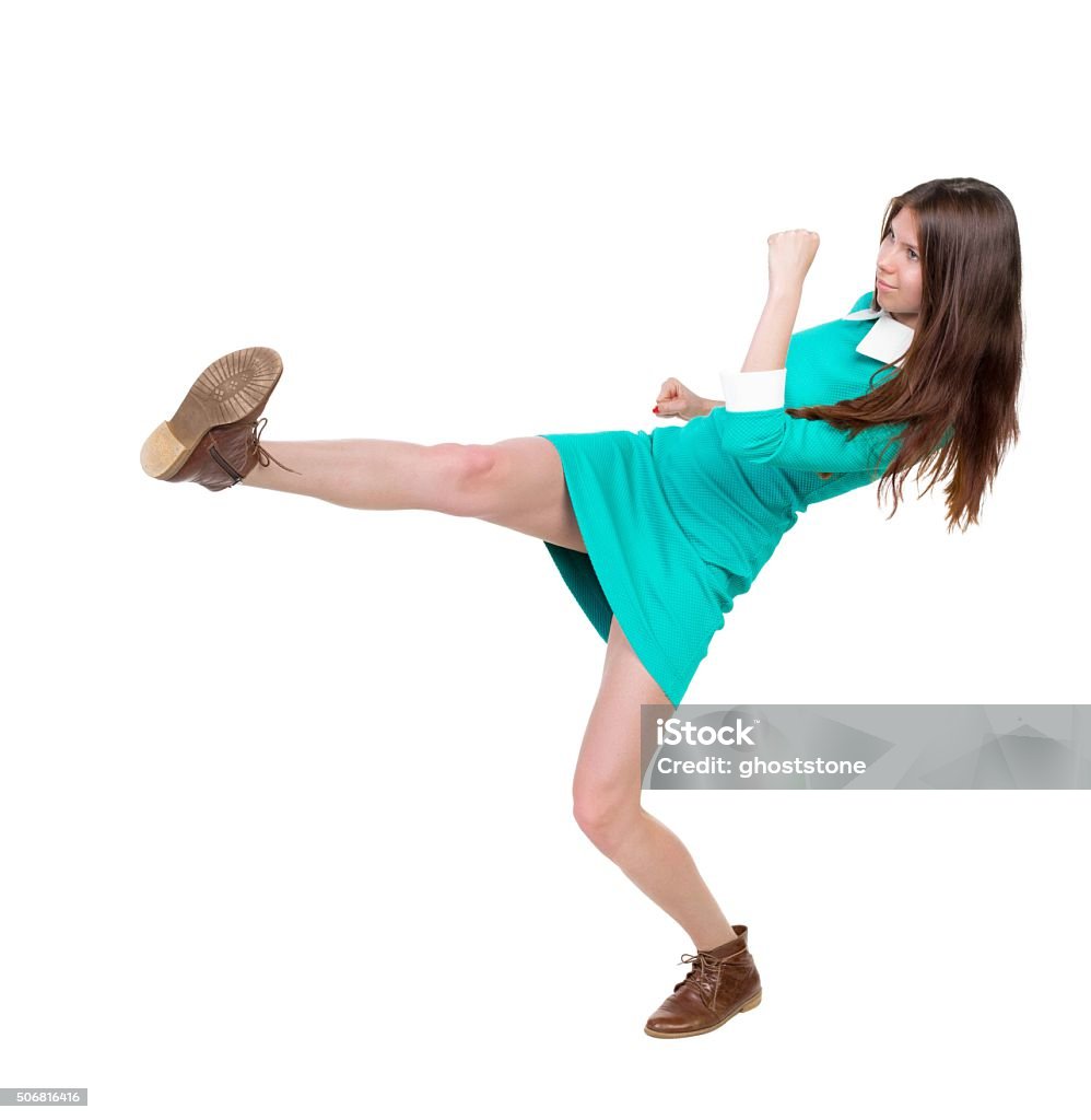 skinny woman funny fights waving his arms and legs. skinny woman funny fights waving his arms and legs. Isolated over white background.  Girl in leather boots strikes. Adult Stock Photo