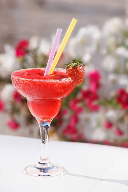  Frozen Strawberry Daiquiri in glass with sugared rim and fresh strawberry, close up