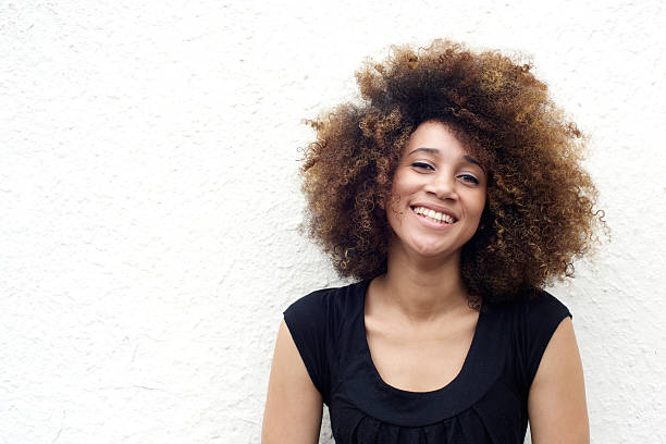 istock Smiling african woman against white background 506820598