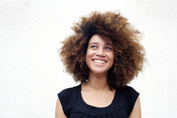 istock Young african woman smiling and looking up 506821172