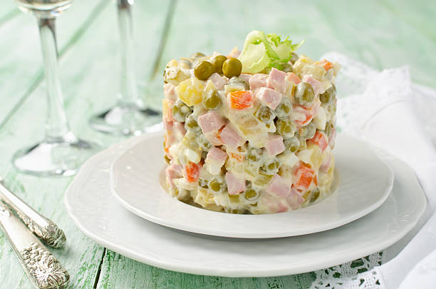 istock Russian traditional salad Olivier with vegetables and meat 506821790