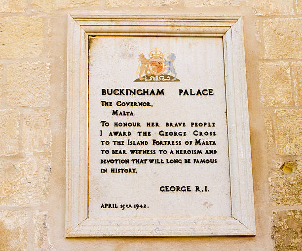 Valettta, Malta: British Plaque Honoring Maltese Citizens for Heroism Valetta, Malta - June 24, 2011: A wall plaque from King George VI (dated 1942) honoring Maltese citizens for their heroism during the 1940-1942 siege of Malta in WWII. The plaque is located on the wall of the Grandmaster's Palace, a building that houses the Maltese Office of the President and the House of Representatives. george vi stock pictures, royalty-free photos & images