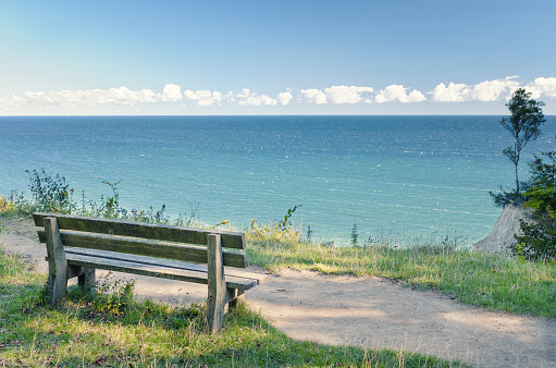 Lonely bench on seacoast footpath