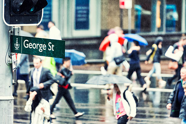 George Street Sydney Color image of the famous George Street in Sydney during a rainy day. Selective focus with copy space right. Some grain added. st george street stock pictures, royalty-free photos & images