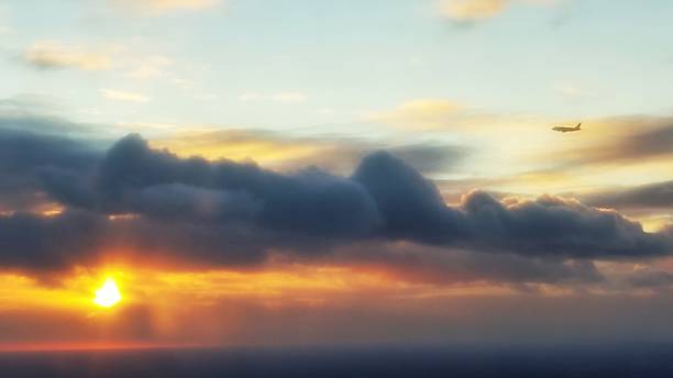 istock One Commercial Airplane Taking Off Ascending, Flying into Sunset 506824950