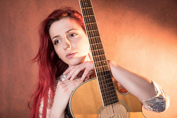 istock Red haired girl with a guitar 506825126