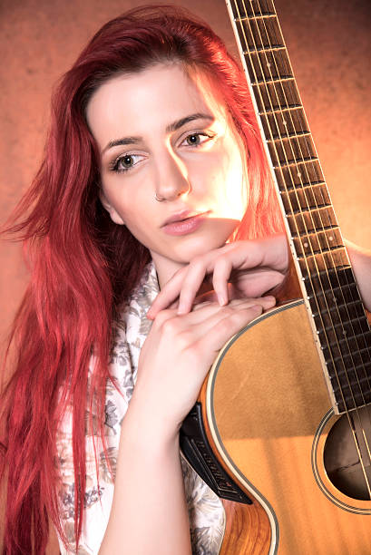 istock Red haired girl with a guitar 506825302