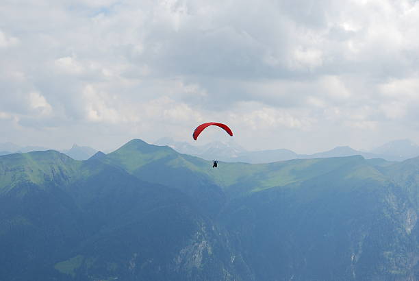 istock Red parachute in the alps 506825552