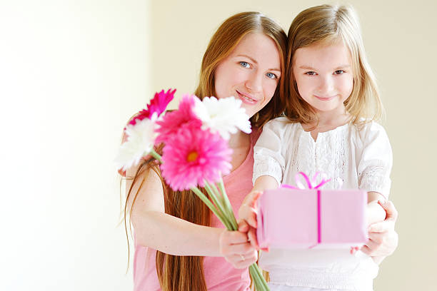 istock Mother and he daughter giving a gift 506826722