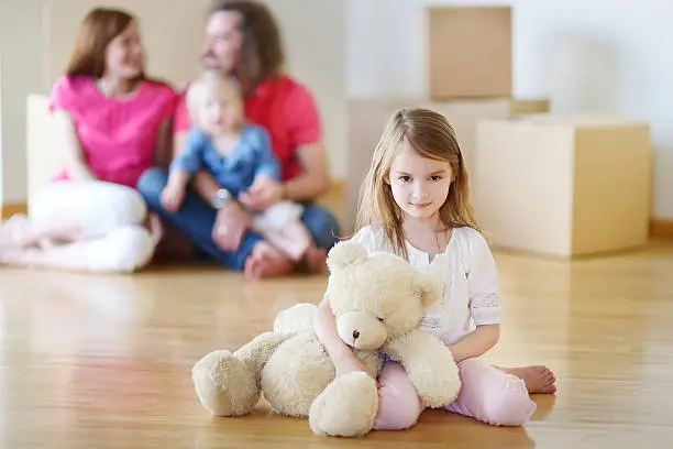 Photo of Happy little girl moving in her new home