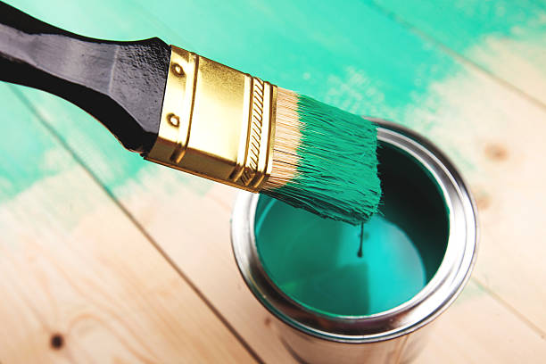 istock Varnishing a wooden shelf using paintbrush 506828190