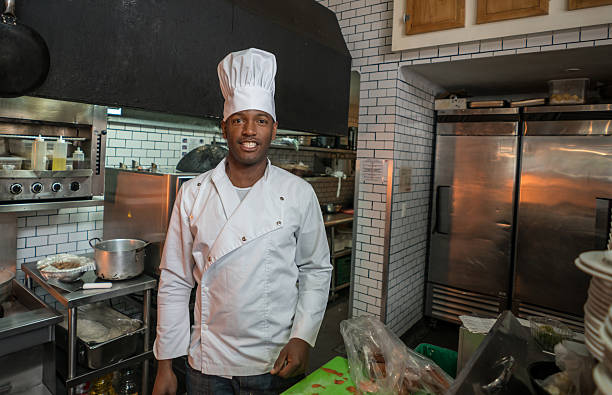 istock Man working as a cook in a restaurant 506829370