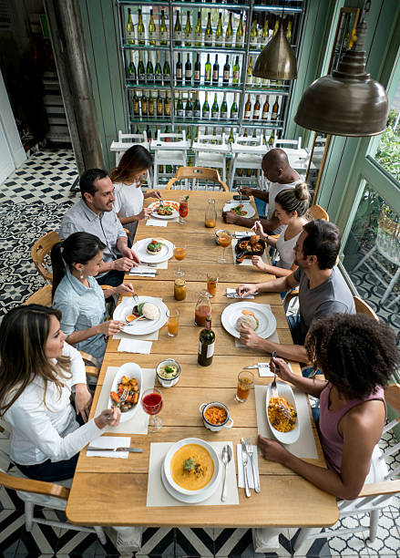 istock Group of friends having dinner at a restaurant 506829674