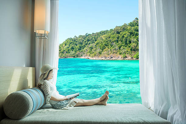 istock Asian woman looking sea view at window in resort, Phuket 506830584