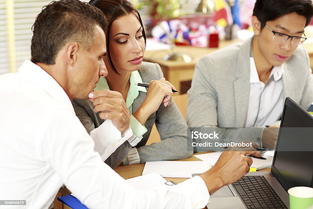 people working around table in office Business people working around table in office Adult Stock Photo
