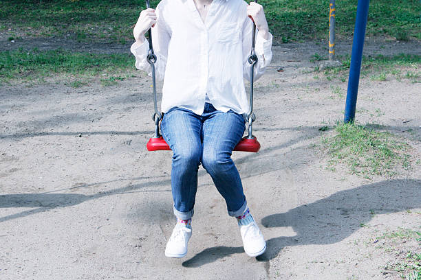 istock Woman riding a swing 506841593