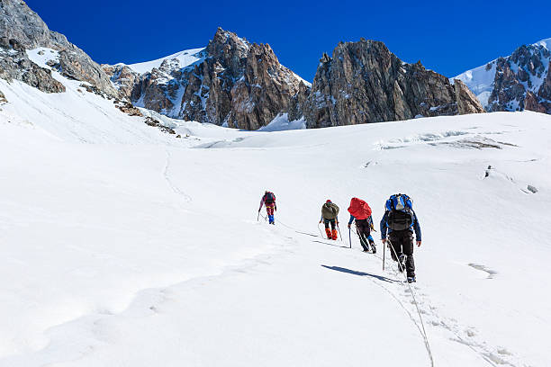 istock team of hikers in winter mountains 506842439