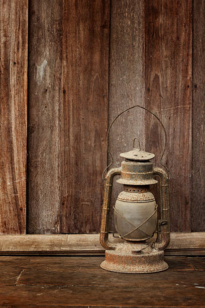 istock Old lantern on wooden background 506842669