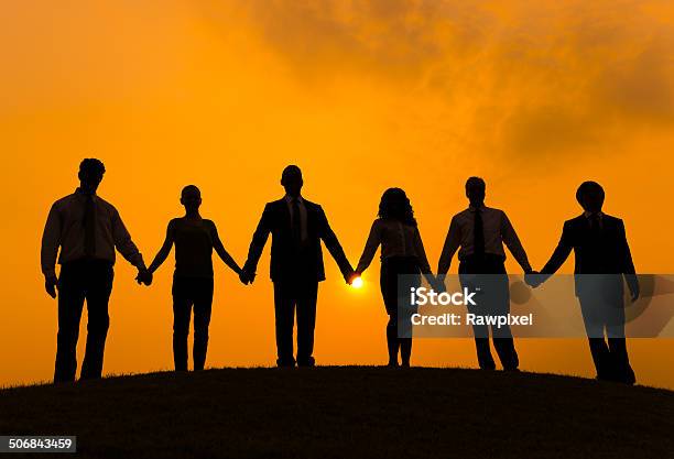 Partnership Stock Photo - Download Image Now - Holding Hands, Group Of People, In Silhouette