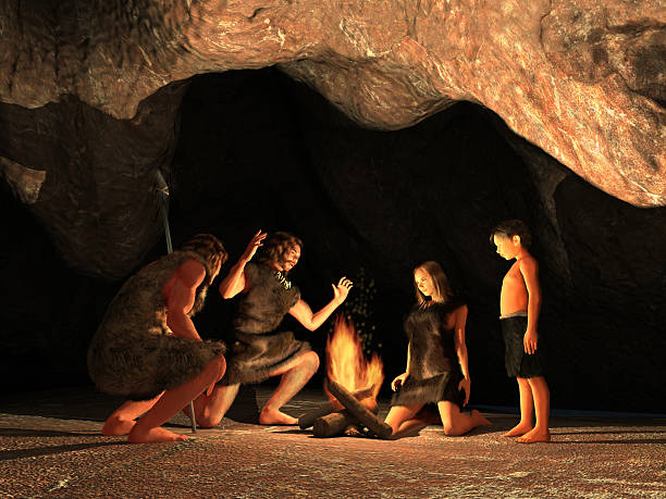 Cave dwellers gathered around a campfire stock photo