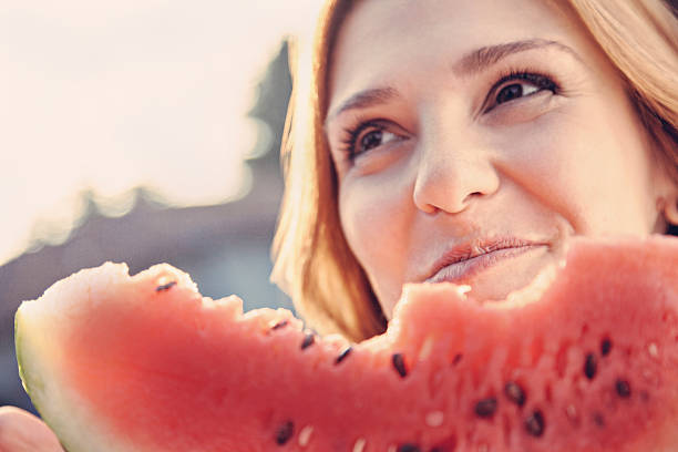 istock Woman Eating Watermelon 506844103