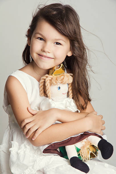 istock Beautiful  girl playing with her doll 506844932