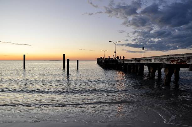 istock Calm Ocean Waters at Sunset with Jetty 506845116