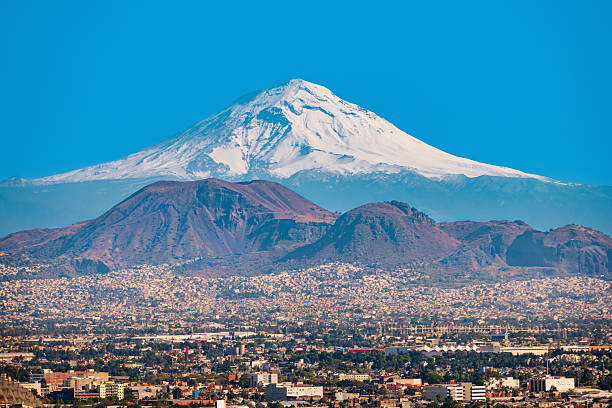 Popocatepetl Volcano and Mexico City View of the snow covered Popocatepetl Volcano as seen from Mexico City, Mexico. mexico city stock pictures, royalty-free photos & images