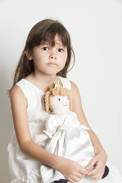 istock Beautiful  girl playing with her doll 506845926