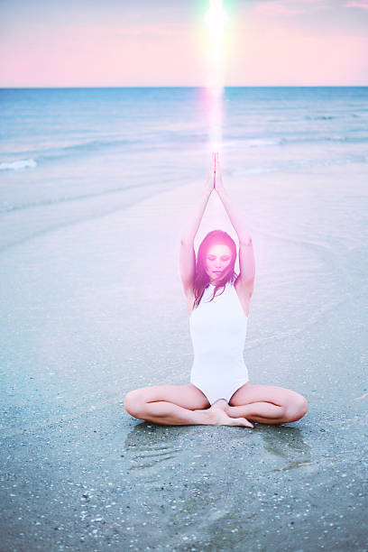 istock Woman doing yoga on seashore 506846177