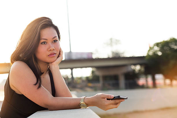 istock Young Woman Holding a Cell Phone 506846215