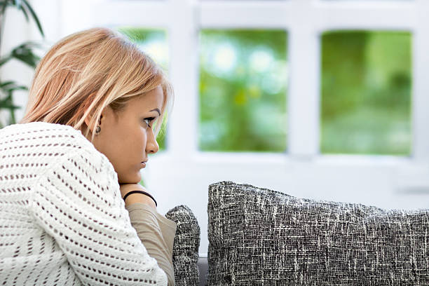 istock Thinking sad woman lying on sofa 506846828