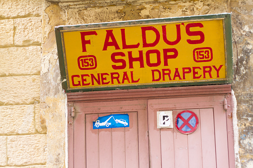 Valetta, Malta - June 2, 2011: A drapery shop with a vintage sign (close-up).
