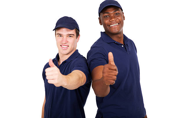 istock blue collar co-workers giving thumbs up 506852530