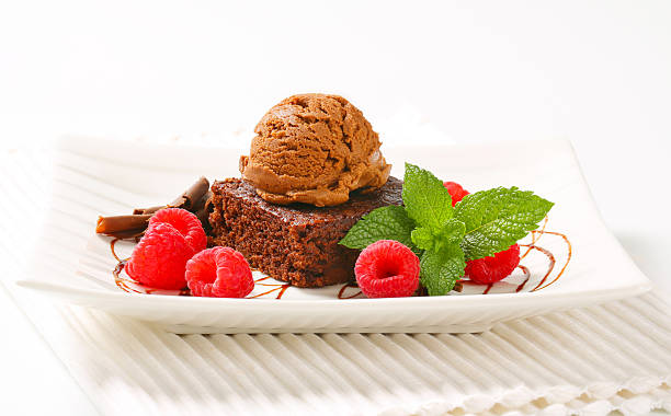 istock Chocolate Brownie with ice cream and raspberries 506852684