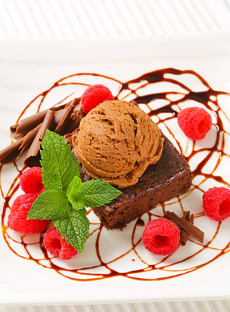 istock Chocolate Brownie with ice cream and raspberries 506852764