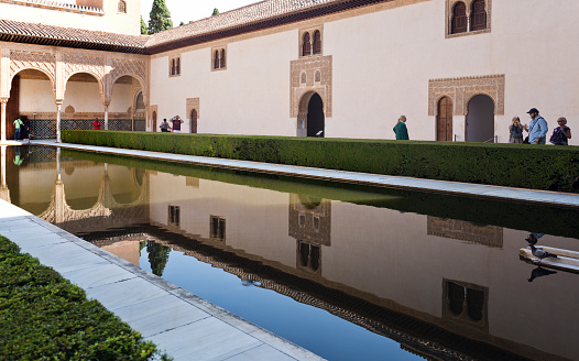 Granada, Spain – September 8, 2015: Tourists visiting the Court of the Myrtles along the central pool, in The Alhambra