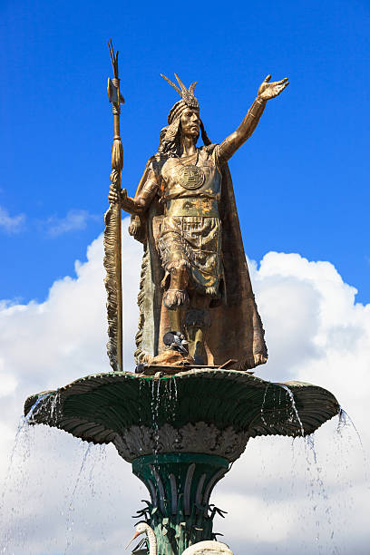 Square of arms of Cuzco by day with the Catholic religious cathedral and the statue and water fountain of the Inca Pachacutec Peru