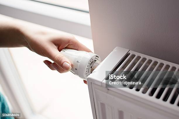Hand Adjusting Thermostat Valve Stock Photo - Download Image Now - Radiator - Heater, Electric Heater, Heat - Temperature
