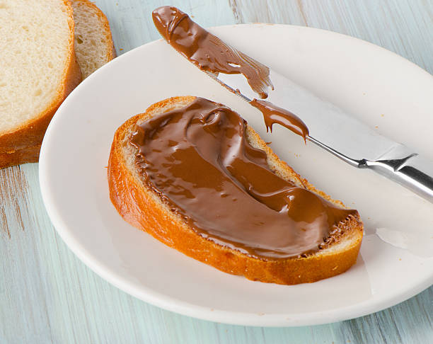 istock bread with chocolate cream on white plate 506858898