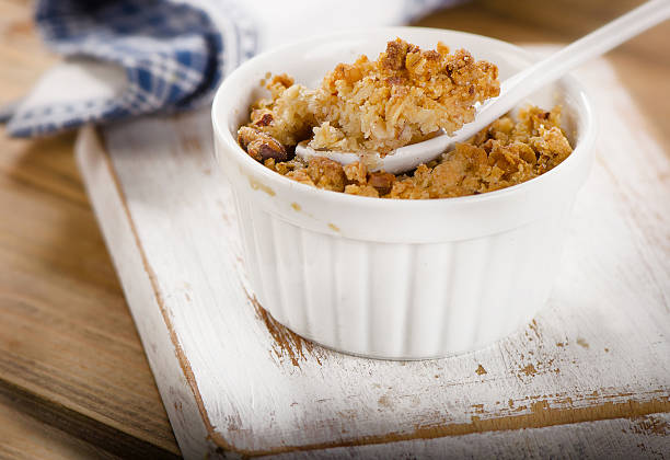 Apple Crumble Dessert on white wooden board. Selective focusApple Crumble Dessert on wooden board. Selective focus