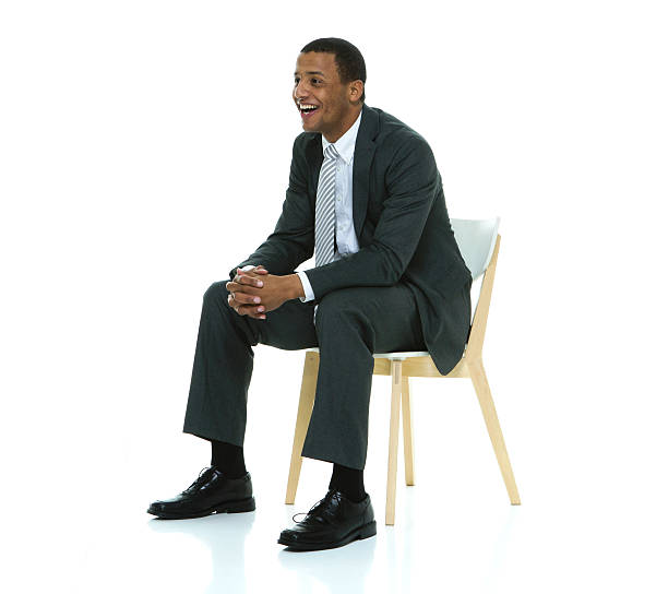 istock Smiling businessman sitting on chair 506859900