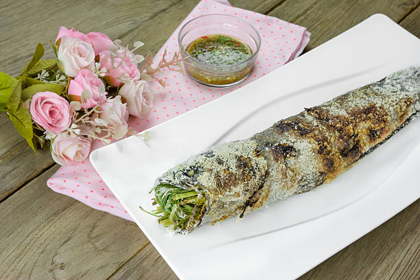 istock grill striped snakehead fish with salt coated 506859920