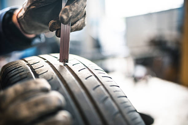 istock car tire repairmen with caliber 506867310