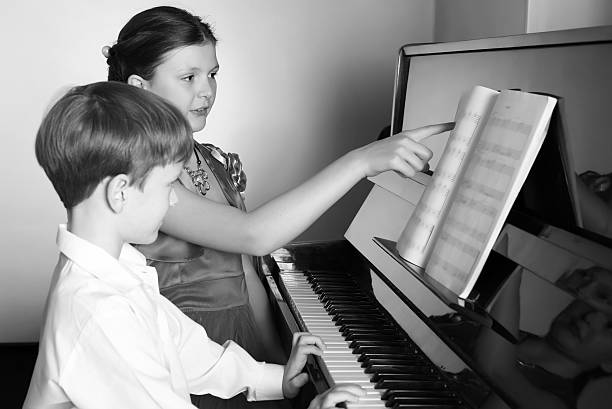 istock Brother And Sister Playing Piano. Piano player. 506867844