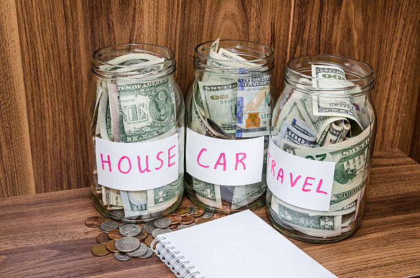 istock empty notepad, dollar in glass jar with us coins 506868160